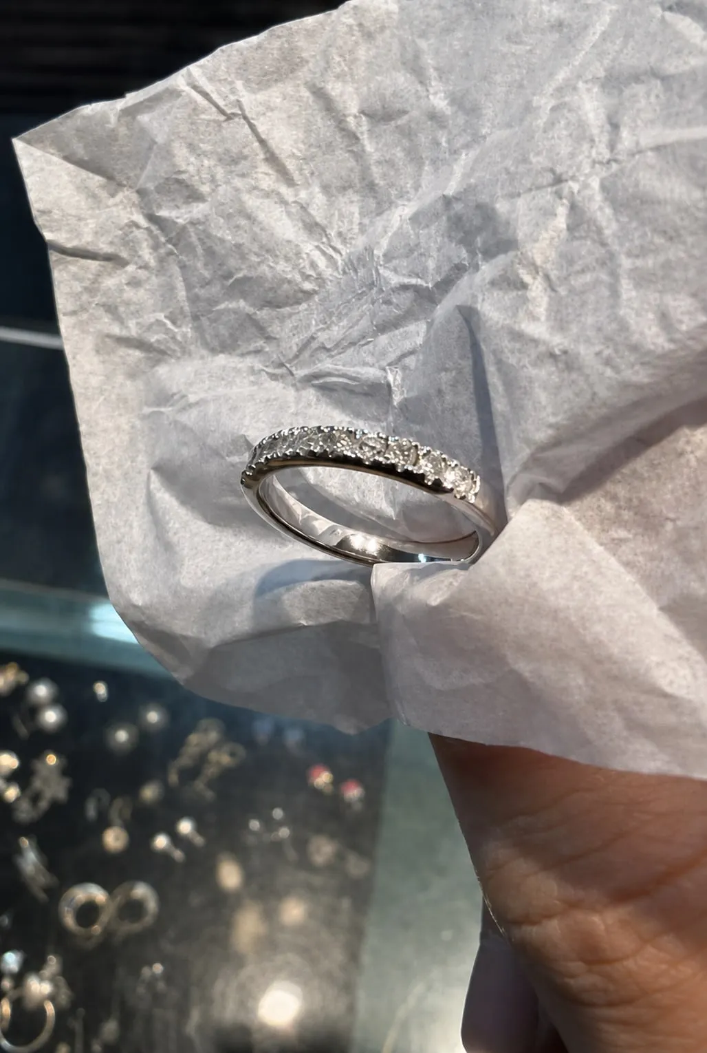 The finished band held in tissue paper over the shop's display case.
