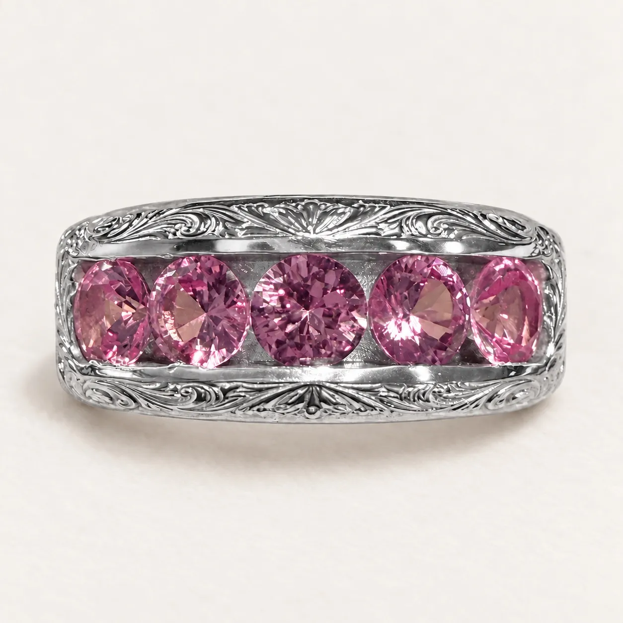Face detail of Redemption showing its five pink stones and scroll-decorated silver rails.