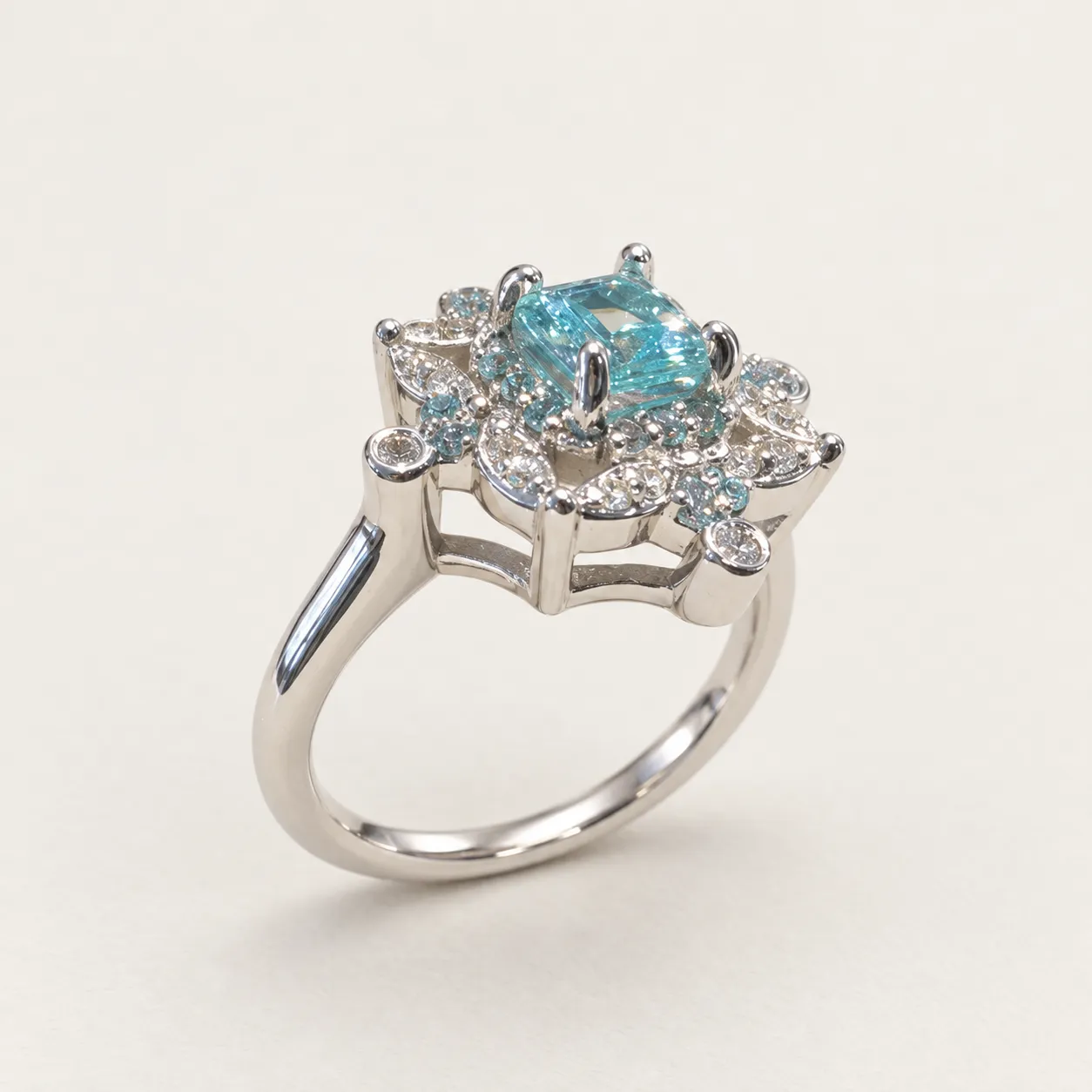 Three-quarter visualization of Natasha’s white-gold ring, with a blue aquamarine center and an ornamental openwork surround.